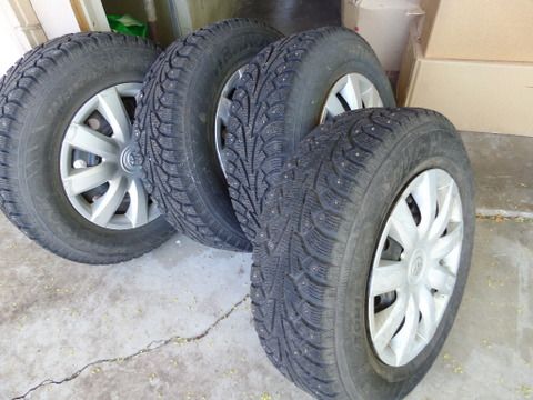 FOUR STUDDED SNOW TIRES MOUNTED ON WHEELS 205/70R15