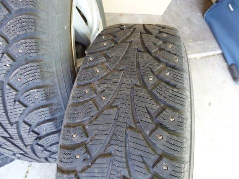 FOUR STUDDED SNOW TIRES MOUNTED ON WHEELS 205/70R15
