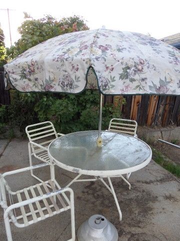 ROUND GLASS TOP PICNIC TABLE WITH 3 CHAIRS AND A LOUNGE CHAIR, PLUS UMBRELLA