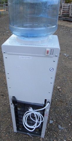G E WATER COOLER WITH STORAGE COMPARTMENT BELOW