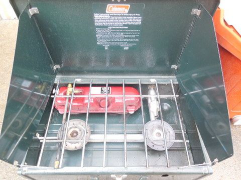 CAMPING GEAR - TWO BURNER COLEMAN STOVE, WATER COOLER, METAL ICE CHEST & SLEEPING BAGS