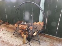 WROUGHT IRON ROUND FIREWOOD HOLDER, WITH FIRE TOOLS AND WOOD