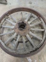 ANTIQUE TRUCK WHEEL WITH IRON RIM AND WOODEN SPOKES