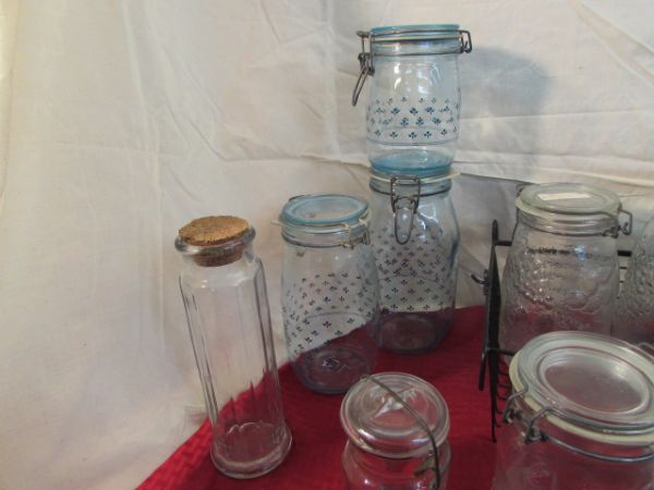 THIRTEEN GLASS JARS MOST WITH WIRE SEAL TOPS