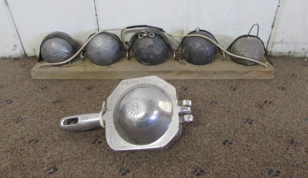 FIVE LEAD BALL WEIGHTS & A METAL FORM