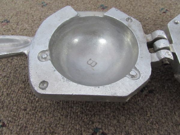 FIVE LEAD BALL WEIGHTS & A METAL FORM