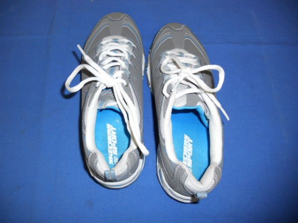 A COMFORTABLE PAIR OF SKECHERS TENNIS SHOES