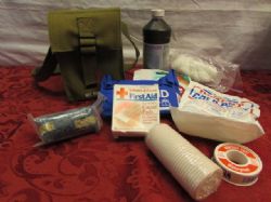 NEVER USED  MILITARY TYPE FIRST  AID KIT IN STURDY CANVAS BAG.