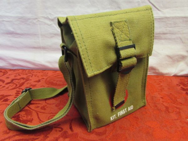 NEVER USED  MILITARY TYPE FIRST  AID KIT IN STURDY CANVAS BAG.