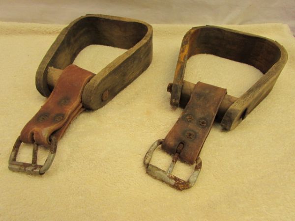 A PAIR OF WOOD STIRRUPS WITH LEATHER STRAPS