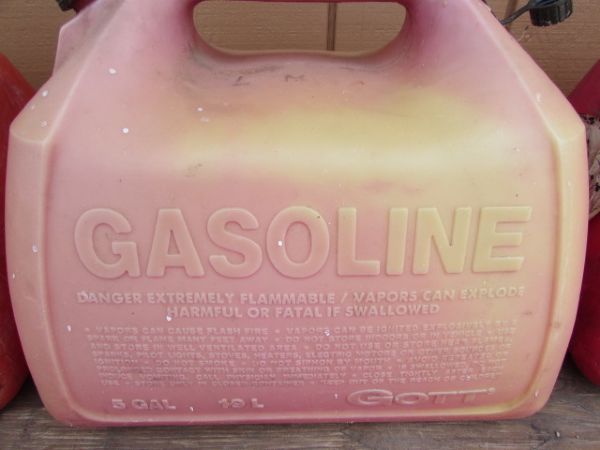 THREE RED 5 GALLON GAS CANS