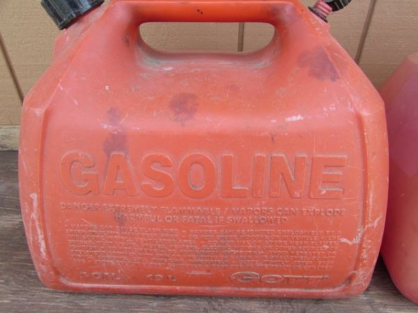 THREE RED 5 GALLON GAS CANS