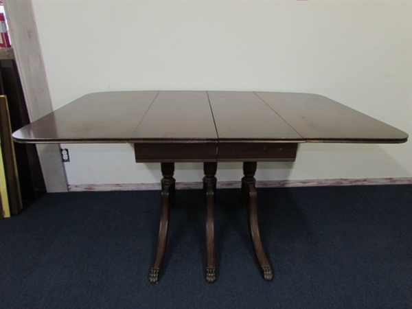 ANTIQUE DROP LEAF TABLE WITH TRIPLE PEDESTAL BASE, CLAW CAPPED FEET, 3 ADDITIONAL LEAFS & TABLE PROTECTOR PADS 
