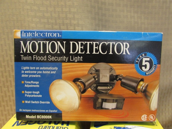 NEW IN BOX MOTION DETECTOR LIGHT, HALOGEN LIGHT BULBS & PROTECTIVE CAGE