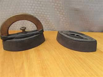 TWO ANTIQUE FLAT IRONS, ONE WITH WOODEN HANDLE