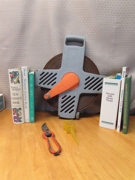 KEEP THE PLACE NEAT WITH COMPACT ROLL AWAY HOSE, AN ASSORTMENT OF GARDENING BOOKS & MORE