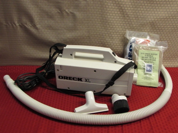 ORECK XL HAND HELD CANISTER VACUUM WITH ATTACHMENTS & 24 BAGS