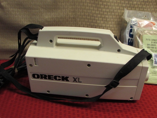 ORECK XL HAND HELD CANISTER VACUUM WITH ATTACHMENTS & 24 BAGS