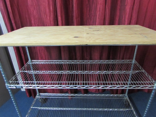 METAL BAKERS RACK WITH PLYWWOD TOP AND CASTOR WHEELS