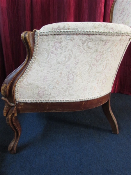 ANTIQUE UPHOLSTERED WINGBACK CHAIR WITH CARVED MAHOGANY LEGS & FRAME