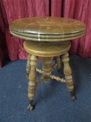ANTIQUE PIANO STOOL WITH GLASS CLAW FEET.