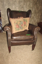 ANTIQUE NAUGAHYDE CHAIR WITH FRONT WHEELS