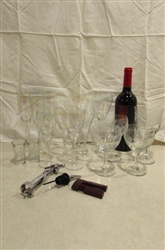 WINE BOTTLE WITH ACCESSORIES AND A VARIETY OF GLASSES