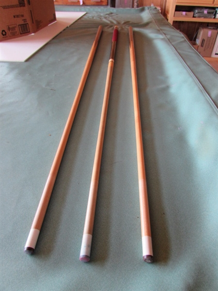 POOL CUE STICKS IN RACK AND BILLIARDS BOOKS WITH CHALK