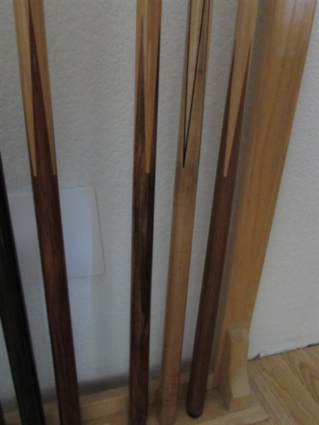 POOL CUE STICKS IN RACK AND BILLIARDS BOOKS WITH CHALK