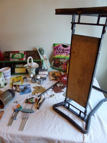 OVERSTUFFED BASKET FULL OF GARDENING SUPPLIES, FOLDING MINI BENCH, WIND CHIMES, BIRD HOUSE, POT LIFTERS