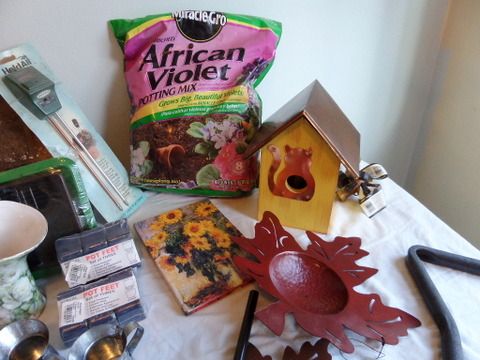 OVERSTUFFED BASKET FULL OF GARDENING SUPPLIES, FOLDING MINI BENCH, WIND CHIMES, BIRD HOUSE, POT LIFTERS