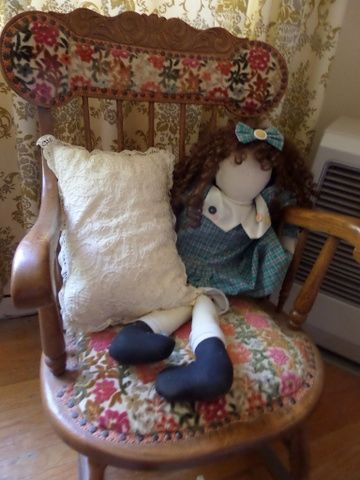 ANTIQUE OAK ROCKER CHAIR WITH UPHOLSTERED SEAT AND BACK. NEEDLE POINT FOOT STOOL,  LARGE RAG DOLL