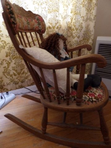 ANTIQUE OAK ROCKER CHAIR WITH UPHOLSTERED SEAT AND BACK. NEEDLE POINT FOOT STOOL,  LARGE RAG DOLL