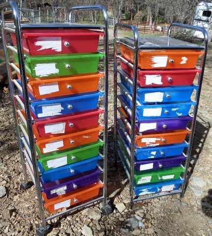 TWO BRIGHT COLORED STORAGE DRAWERS WITH OFFICE SUPPLIES