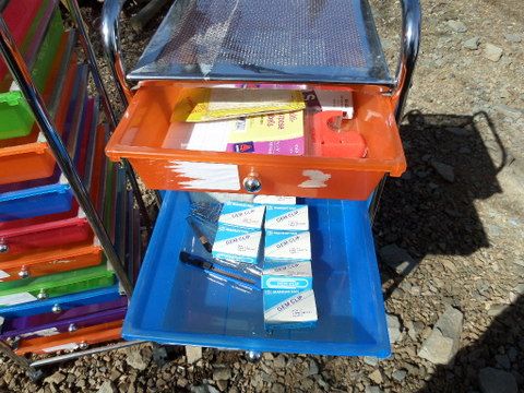 TWO BRIGHT COLORED STORAGE DRAWERS WITH OFFICE SUPPLIES