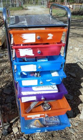 TWO BRIGHT COLORED STORAGE DRAWERS WITH OFFICE SUPPLIES