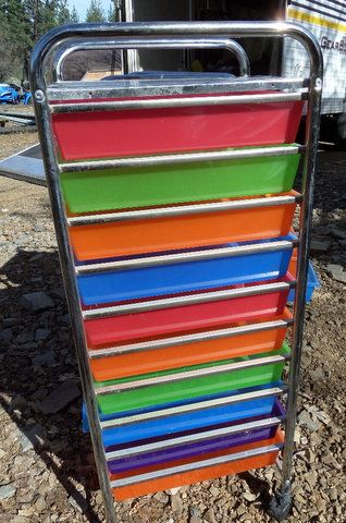 TWO BRIGHT COLORED STORAGE DRAWERS WITH OFFICE SUPPLIES