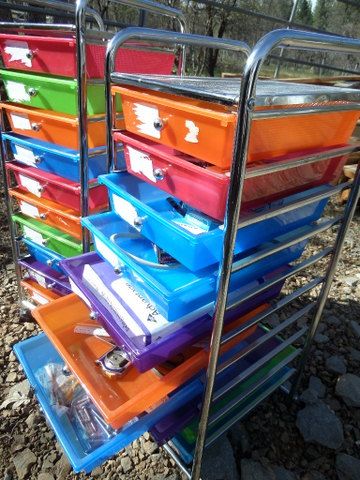 TWO BRIGHT COLORED STORAGE DRAWERS WITH OFFICE SUPPLIES