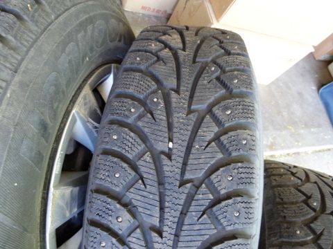 FOUR STUDDED SNOW TIRES MOUNTED ON WHEELS 205/70R15