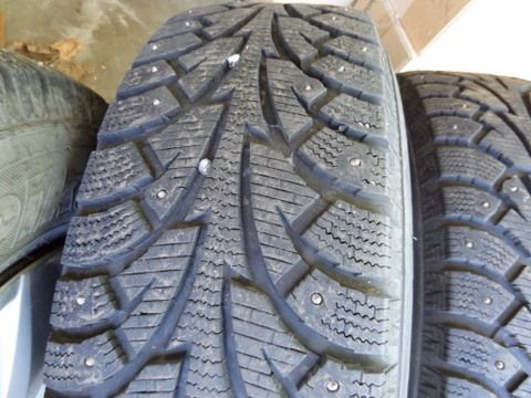 FOUR STUDDED SNOW TIRES MOUNTED ON WHEELS 205/70R15