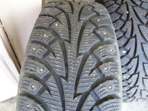 FOUR STUDDED SNOW TIRES MOUNTED ON WHEELS 205/70R15