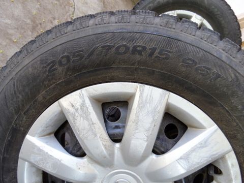 FOUR STUDDED SNOW TIRES MOUNTED ON WHEELS 205/70R15