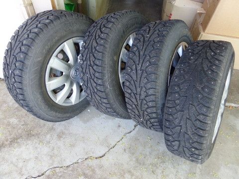 FOUR STUDDED SNOW TIRES MOUNTED ON WHEELS 205/70R15