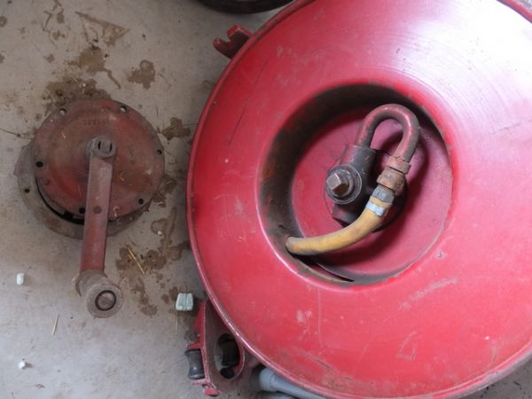 VINTAGE RED REEL WITH WHAT APPEARS TO BE GREASE HOSE