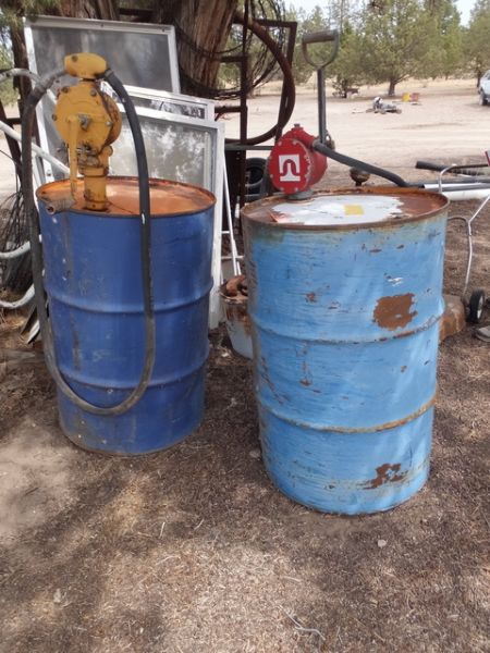 TWO FIFTY GALLON METAL DRUMS WITH PUMPS