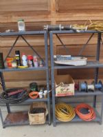TWO METAL SHELVES WITH CONTENTS - NAILS, GREASE GUN, ELECTRICAL WIRE AND MORE