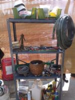 METAL SHELVING UNIT WITH LOADS OF GARDEN SUPPLIES AND VINTAGE TOOLS