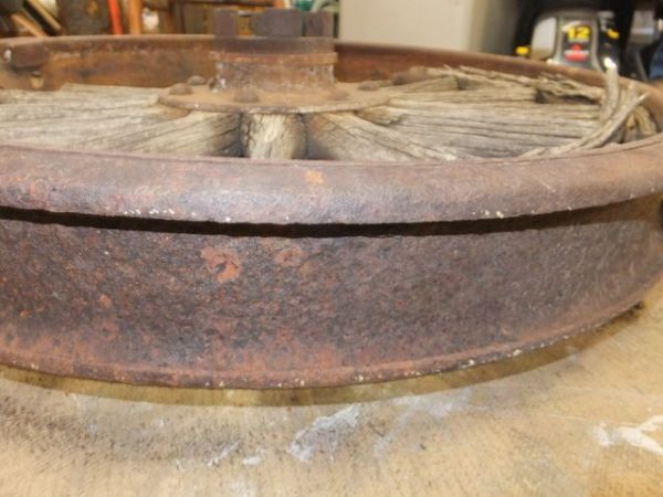 ANTIQUE TRUCK WHEEL WITH IRON RIM AND WOODEN SPOKES