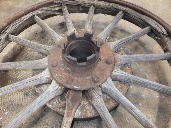 ANTIQUE TRUCK WHEEL WITH IRON RIM AND WOODEN SPOKES