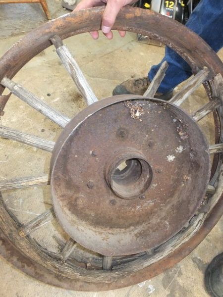 ANTIQUE TRUCK WHEEL WITH IRON RIM AND WOODEN SPOKES